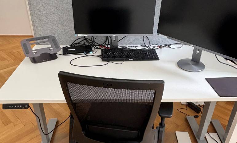 Arbeitsplätze mit Doppelmonitoren vor einer Akustikwand